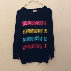 529 long sleeve sweater with slits and sequins.